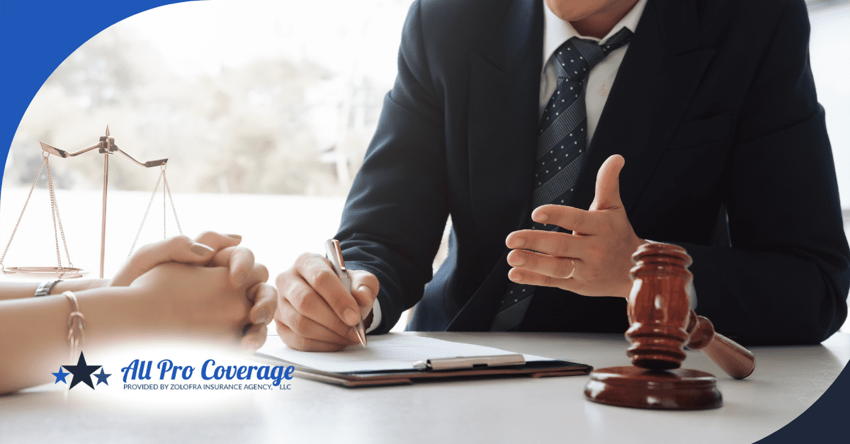 Business professional discussing contract details with client across a desk, with legal scales visible.