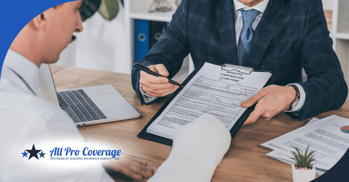 Injured worker reviewing a workers’ compensation claim form with an insurance agent.