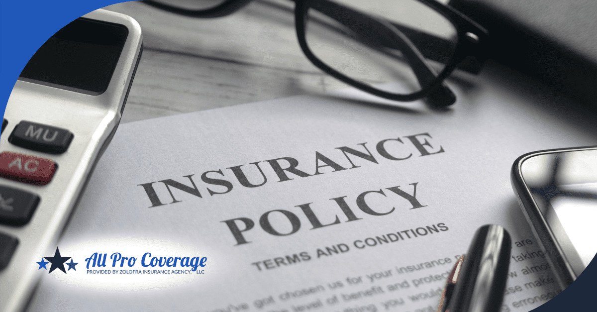 Insurance policy document with calculator, glasses, and pen on the desk.