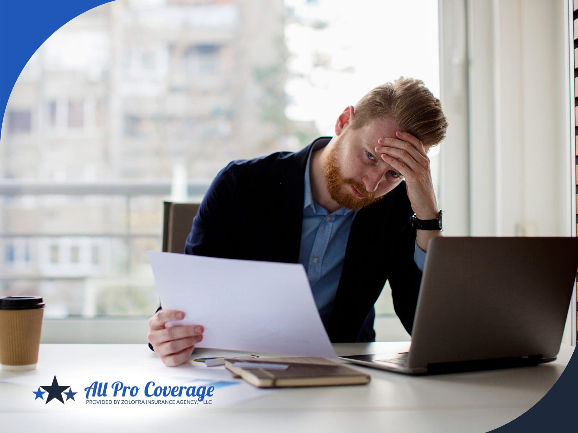 Worried businessman reviewing insurance documents at his desk.