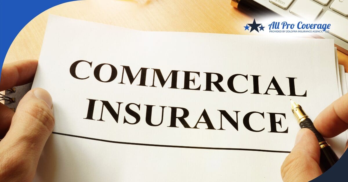 Close-up of a hand writing on a commercial insurance document.