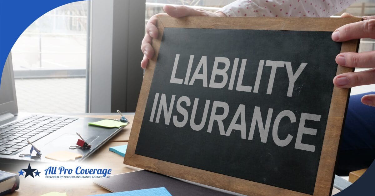 Person holding a chalkboard with "LIABILITY INSURANCE" written on it.