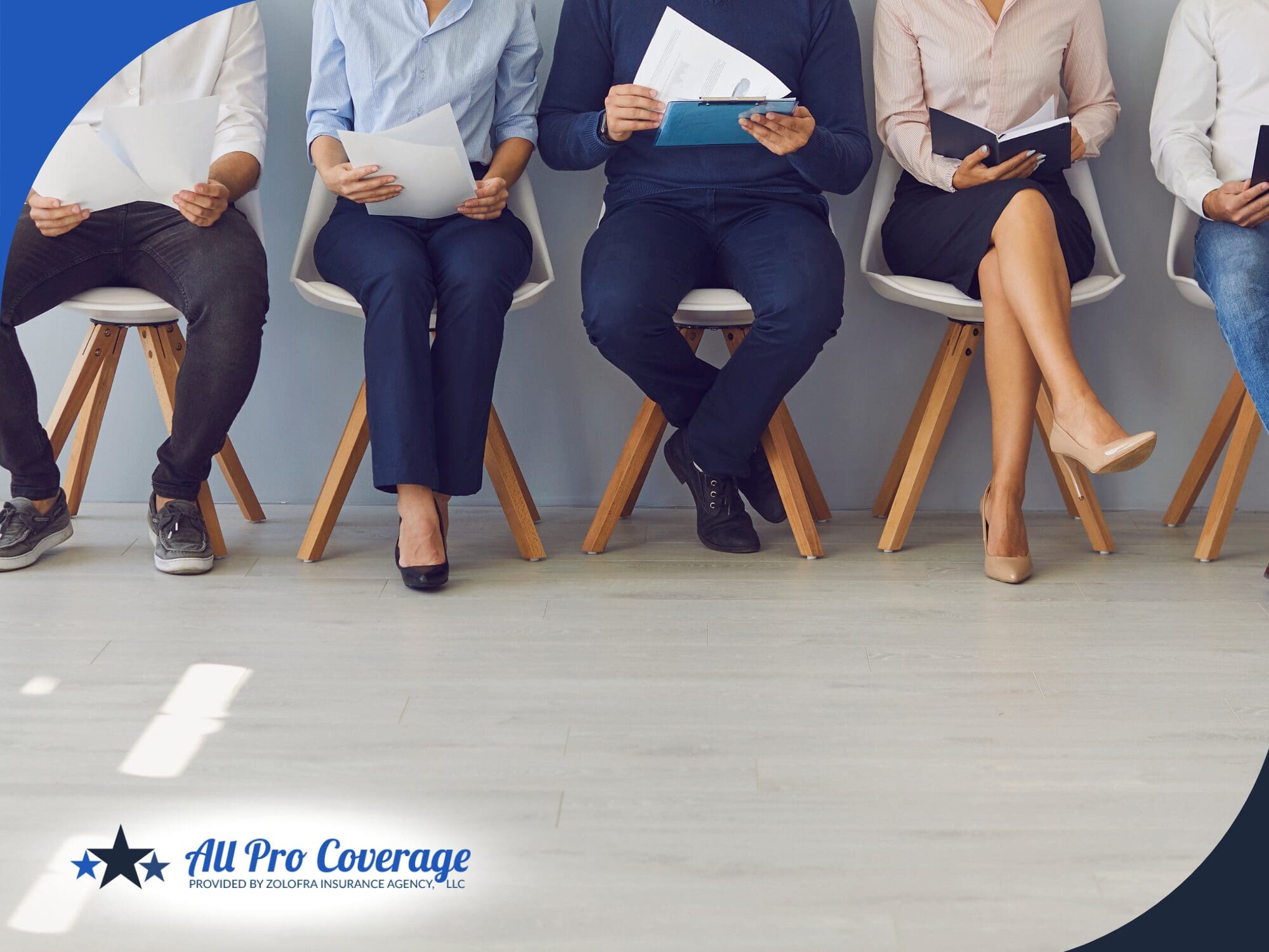 Job applicants sitting in a row holding resumes.